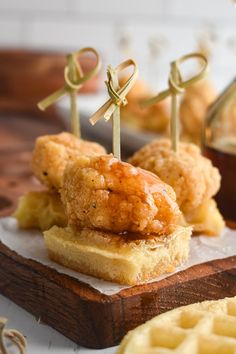 fried chicken and waffle skewers on a wooden board with the words chicken & waffle skewers