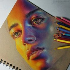 a drawing of a woman's face with colored pencils next to it