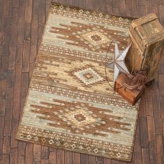 a brown and white rug on top of a wooden floor next to an old box