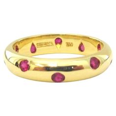 TIFFANY & Co. Etoile 18K Gold Ruby Band Ring 5 Metal: 18K Yellow Gold Size: 5 Band Width: 4mm Weight: 4.30 grams Ruby: 10 round rubies, carat total weight .25 Hallmark: TIFFANY&CO. 750 Condition: Like new Limited edition, no longer available for sale in Tiffany stores Authenticity Guaranteed Ruby Band Ring, Ruby Bands, Ring Ideas, Modern Ring, Tiffany And Co, Modern Jewelry, Tiffany & Co., Band Ring, Hallmark