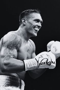 a black and white photo of a man wearing boxing gloves