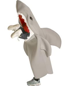 a toy shark with its mouth open and shoes in it's mouth, standing upright