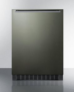 a stainless steel dishwasher sitting on top of a metal counter next to a white wall