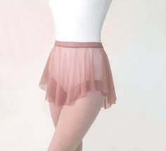 there is a woman wearing a pink tutu skirt and tights on her feet