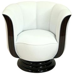 a white chair with black trim around the armrests and an oval shaped seat