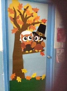 an owl door decoration with leaves on it