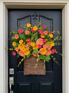 a basket filled with flowers sitting on top of a door