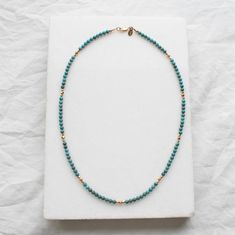 Stunning and chic this beaded turquoise necklace is the perfect everyday necklace or gift. Perfect for December birthdays, turquoise is the talisman of luck! •Gorgeous, genuine and natural 3mm Kingman Turquoise beaded by hand This turquoise is from a local Arizona mine in Kingman Arizona. •Adorned with 14kt gold filled accents Model is wearing 16" in Photos. Water friendly Single Strand Amazonite Beaded Necklaces As Gift, Gift Amazonite Single Strand Beaded Necklace, Turquoise Single Strand Amazonite Necklace, Adjustable Single Strand Amazonite Beaded Necklace, Turquoise Single Strand Necklace In Amazonite, Turquoise Amazonite Single Strand Necklace, Spiritual Single Strand Turquoise Necklace, Gift Amazonite Beaded Necklace With Polished Beads, Everyday Bohemian Turquoise Necklace