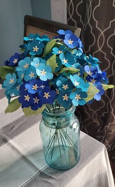 a vase filled with blue flowers on top of a table