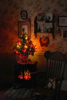 a small christmas tree is lit up in the dark