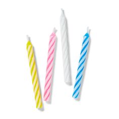 three birthday candles are lined up in different colors