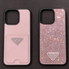 two pink cases sitting next to each other on top of a black surface with silver sequins