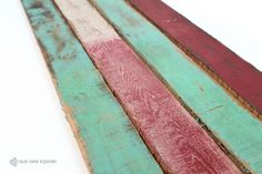 three different colored wood planks sitting on top of each other