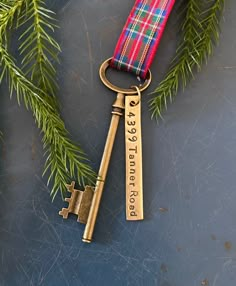 a keychain with a red and blue plaid ribbon attached to it