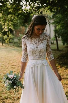 a woman in a white dress holding a bouquet