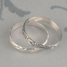 Antique Style Ring Romance in the Garden Sterling Silver Wedding Band Stacking Ring Patterned Silver Ring Flower Band Vintage Style Ring This lovely little ring is hand forged from solid sterling silver pattern wire. It features a deco flower pattern with lines and a daisy around the entire surface. It is 2.75mm wide and a slim .7mm thick. It can be made just for you in any size and can be either oxidized and brushed (top) or high polished (bottom). Looking for a set? https://www.etsy.com/listin Stackable Flower Ring For Wedding, Stackable Flower Ring With Round Band For Wedding, Hand Forged Engraved Wedding Ring, Hand Forged Engraved Round Wedding Ring, Nickel Free Adjustable Stackable Wedding Rings, Adjustable Nickel-free Stackable Rings For Wedding, Adjustable Stackable Toe Rings For Wedding, Handmade Stackable Round Wedding Rings, Adjustable Hallmarked Engraved Wedding Ring