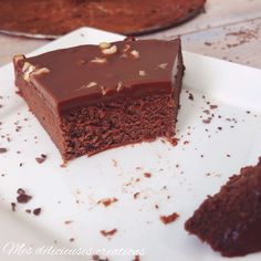 a piece of chocolate cake sitting on top of a white plate