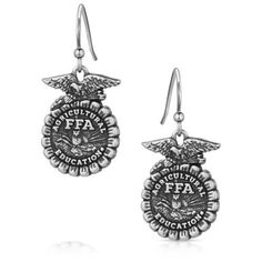 Show your love for the FFA Organization with the FFA Emblem Earrings. The earrings feature an etched FFA emblem in an antiqued silver tone. The earrings depict the FFA emblem in stunning detail. An etched eagle sits atop the cross section of corn. Through the center "Agriculture Education" and "FFA" are clearly visible. The rising sun serves as the backdrop for the plow and owl in the center. These earrings will make the perfect gift to any FFA member, advisor, and alumni in your life. The earrings are secured by hypoallergenic French wires. Earrings have French wires for easy wear. All Montana Silversmiths jewelry and accessories are coated with Montana Armor to prevent tarnish. These earrings have french wires for easy wear. Celebrate our future farmers with the FFA emblem. A silver fini Ffa Emblem, Montana Silversmith Jewelry, Agriculture Education, Cross Section, Ffa, Tractor Supply, The Rising Sun, French Wire, Rising Sun