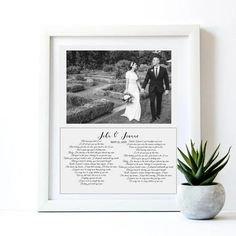 a wedding poem is displayed in front of a potted plant and a framed photo