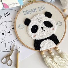 a panda bear is sitting on the table next to some crafting supplies