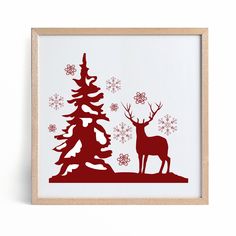 a red silhouette of a deer standing next to a tree with snowflakes on it