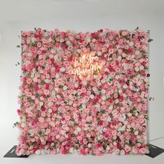 a pink flower wall with the words happy birthday written on it