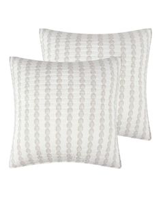 two white pillows sitting next to each other