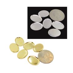 some gold and silver buttons next to a penny on a white surface with black background