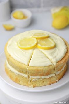 there is a cake with lemons on it and white frosting in the middle