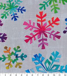 a white background with multicolored snowflakes printed on it and a ruler