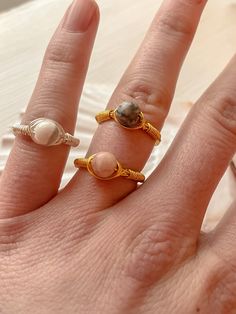 simple tarnish free marble rings  wire colors- silver and gold  bead colors- white marble, pink marble, black marble ring sizing-  sizes range from US 2 to US 15 if you are unsure of your ring size, use the website below to measure it at home https://www.realsimple.com/beauty-fashion/shoes-accessories/jewelry/how-to-measure-ring-size Minimalist Adjustable Wire Wrapped Rings, Adjustable Gold Wire Wrapped Rings, 14k Gold Wire-wrapped Rings, Rose Quartz Ring Wire, Bohemian Wire Wrapped Adjustable Crystal Ring, Marble Rings, Measure Ring Size, Gold And Silver Rings, Wire Rings