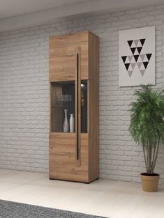 a tall wooden cabinet sitting next to a potted plant