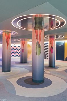 there is a circular room with many different designs on the walls and floor, as well as round columns