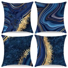 four pillows with blue and gold designs on the front, one has an abstract design