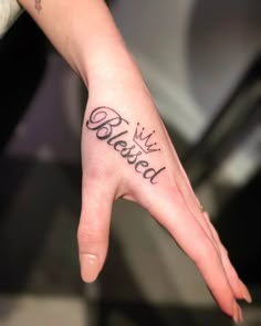 a person's hand with the word beloved tattooed on it, in black ink