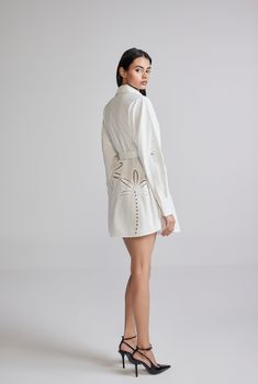 The Lani White Short Shirt Dress is an ethereal breezy style from the Resort'24 Collection. Armed with the versatility of white and the comfort of cotton poplin, the dress features Battenburg lace embroidery, a shirt collar with a button-down closure., and full sleeves with a cuff. Oozing casual elegance, the dress gently curves at the hem and cinches at the waist with a tie-up belt. A perfect style for champagne brunches! Made In India White Embroidered Cotton Poplin Shell - 100% Cotton Curved Short Shirt Dress, Curved Hem Shirt, Breezy Style, Battenburg Lace, Hemant And Nandita, Short Shirt, White Shirt Dress, Perfect Style, Lace Embroidery