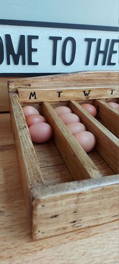 some eggs are in wooden crates on a table