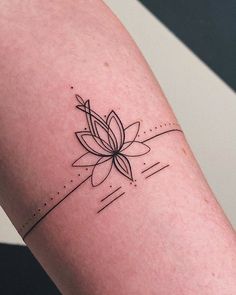 a black and white photo of a flower tattoo on the left arm, with lines running through it