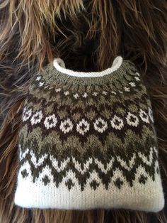 a close up of a handbag on a furry animal's fur surface,