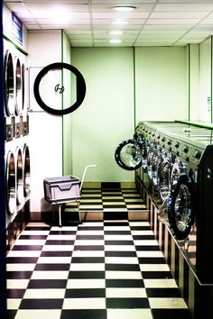 a row of washing machines in a room with black and white checkered flooring