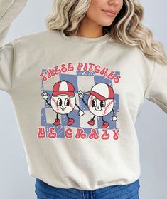 You'll love this vintage cartoon baseball sweatshirt! The soft, comfy material is made from a blend of cotton and polyester. There are no itchy side seems and it has a trendy, loose fit. The retro animated design on this sporty baseball crewneck is super cute and makes a great gift for the baseball lover in your life! Please use the sizing guide for additional guidance on sizing! This Sweatshirt is a Unisex-style, so it has a smaller fit than men's sizing, but a little larger fit than women's si Long Sleeve Graphic T-shirt For Baseball Season, Long Sleeve T-shirt With Graphic Print For Baseball Season, Long Sleeve Graphic Print T-shirt For Baseball Season, Character Print Crew Neck Top For College, Sporty Cotton Sweatshirt With Character Print, Varsity Sweatshirt With Graphic Print For Baseball Season, Varsity Sweatshirt With Graphic Print For Sports Season, Casual Sweatshirt With Character Print, Crew Neck, Trendy Crew Neck Sweatshirt With Character Print