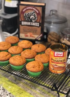 muffins on a cooling rack next to a can of pumpkin spice