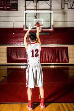 a basketball player is getting ready to dunk the ball