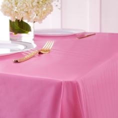 a pink table cloth with a gold fork on it