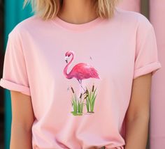 Tropical Pink Flamingo Holiday Vibe T-Shirt is the perfect gift for yourself when planning your summer vacation or Tropical get away.  A perfect send off gift or Pink Flamingo Lover T-Shirt birthday gift.  Inspires warm feelings of the tropics and happy vacation fun to come. Soft cotton quality print make wearers fall in love with it over and over again.  These t-shirts have ribbed knit collars to bolster shape and maintain great style.  The shoulders have taping for better fit and wear over tim Summer Short Sleeve Top With Flamingo Print, Summer Flamingo Print Short Sleeve Tops, Short Sleeve Flamingo Print Summer Top, Summer Pink Flamingo Print Top, Pink Tropical T-shirt In Relaxed Fit, Flamingo Tshirt, Pink Flamingo Print T-shirt For Summer, Casual T-shirt With Flamingo Print For Summer, Happy Vacation