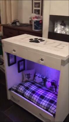 a bed that has been built into the side of a cabinet with lights on it