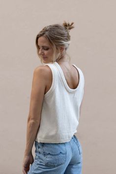 The makali tank top is knitted from the softest cashmere and organic cotton blend that feels smooth against the skin and doesn't itch. it is light and airy for summer and has a slight oversized fit. effortless to layer and easy to tuck in. it is made from leftover yarn that is undyed which makes it even more sustainable.    70% organic cotton 30% recycled cashmere. made in lithuania in a small family owned factory.    model is wearing size xs. White Scoop Neck Tank Top For Layering, Chic Spring Sweater Vest For Everyday, Chic White Crew Neck Sweater Vest, Cream Soft Knit Top For Everyday, Everyday Soft Knit Cream Tops, Cream Fine Knit Cotton Top, Versatile White Tank Top For Layering, Everyday Cream Soft Knit Tops, Sleeveless Knit Tops With Relaxed Fit