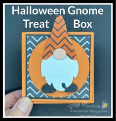 someone is holding up a halloween gnome treat box