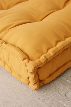 a yellow blanket is laying on the floor