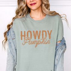 Hey there, autumn lover! Ready to embrace the cozy vibes of the season? Our Howdy Pumpkin Comfort Color Graphic Tee is perfect for showcasing your love for fall with a playful twist. Whether you're heading to a pumpkin patch, enjoying a bonfire, or sipping on your favorite spiced latte, this tee combines comfort with seasonal charm. Crafted from ultra-soft, high-quality cotton, our Howdy Pumpkin Comfort Color Graphic Tee ensures comfort and durability throughout the season. Its relaxed fit and premium fabric keep you cozy and stylish as you enjoy all your favorite fall activities. Featuring a cheerful "Howdy Pumpkin" design, this tee adds a fun and festive element to your autumn wardrobe. It pairs effortlessly with jeans, leggings, or your favorite flannel, making it a versatile piece for Howdy Pumpkin, Autumn Wardrobe, Fall Activities, Jeans Leggings, Cozy Vibes, Comfort Color, Pumpkin Design, Autumn Activities, Hey There